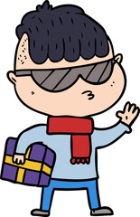 Naklejka premium cartoon boy wearing sunglasses carrying xmas gift