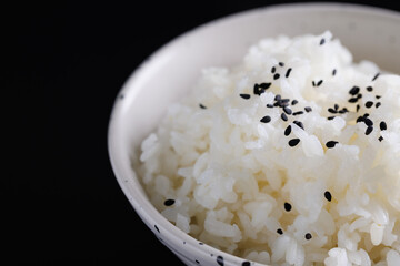 Japanese rice on cup isolated in black background