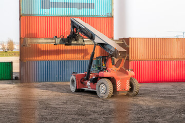 forklift truck with a heavy container imported in a ship from Asia 