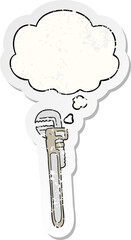 cartoon adjustable wrench with thought bubble as a distressed worn sticker