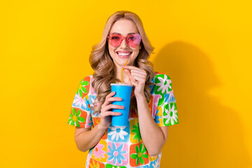 Photo pretty cheerful lady visit movie premiere drink soda paper cup wear heart sunglass print shirt isolated yellow color background
