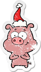happy hand drawn distressed sticker cartoon of a pig wearing santa hat