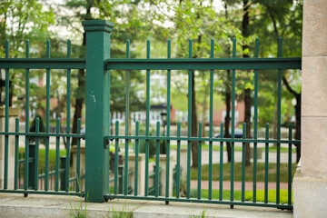 Metal fence symbolizes boundaries, security, protection, privacy, and delineates spaces with its strong and sturdy presence