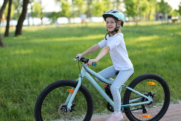 Fototapeta premium Bicycle ride in the park happy girl on a bike.
