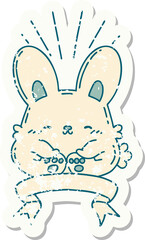 worn old sticker of a tattoo style happy rabbit