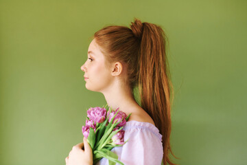 Beauty portrait of pretty young 15 - 16 year old redhaired teeenage girl wearing purple dress...