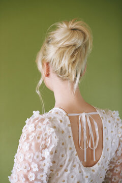 Romantic formal hairstyle on blond hair, back view