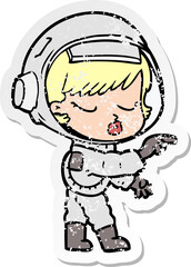 distressed sticker of a cartoon pretty astronaut girl pointing