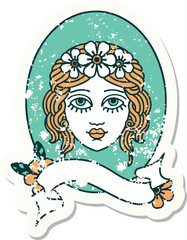 worn old sticker with banner of a maiden with flowers in her hair