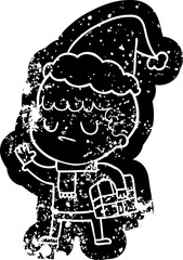 quirky cartoon distressed icon of a grumpy boy wearing santa hat