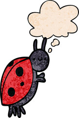 cartoon ladybug with thought bubble in grunge texture style