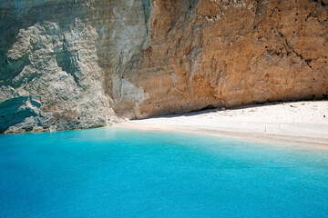 part of Navagio beach with high cliff and turquoise water, touristic famous landmark on Zakynthos island, Greece