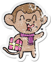 distressed sticker of a crazy cartoon monkey with christmas present