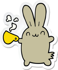 sticker of a cute cartoon rabbit drinking coffee