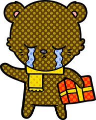 crying cartoon bear with present