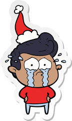 hand drawn sticker cartoon of a crying man wearing santa hat