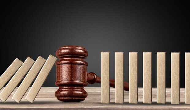 Judge wooden gavel. Stop domino effect concept