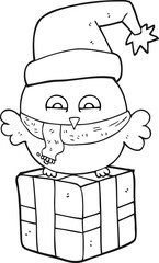 freehand drawn black and white cartoon cute christmas owl on wrapped present