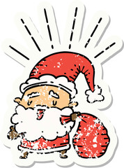 worn old sticker of a tattoo style santa claus christmas character with sack