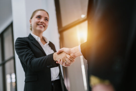 Businesspeople shaking hands indoors. Concept of successful business people shaking hands.