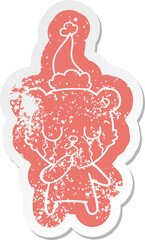 crying polar bear quirky cartoon distressed sticker of a wearing santa hat