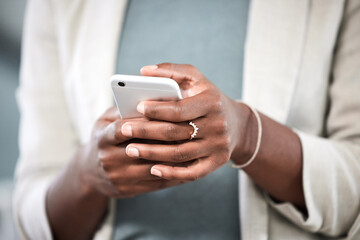Phone, hands and closeup of a businesswoman browsing on social media or the internet. Technology, communication and female employee typing or networking on a mobile app with a cellphone in workplace.