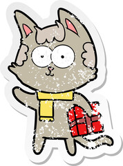 distressed sticker of a happy cartoon cat with christmas present