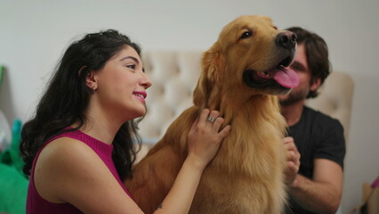Golden Moments_ A Smiling Couple Bonding with their Beautiful Golden Retriever Pet Indoors