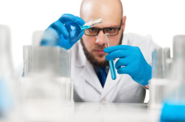 Male researcher carrying out scientific research in a lab with glassware