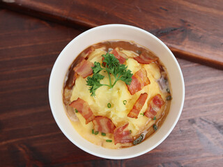 Mashed Potatoes and Bacon with Gravy Sauce in plate on table