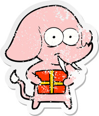 distressed sticker of a happy cartoon elephant with present