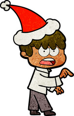 worried hand drawn textured cartoon of a boy wearing santa hat