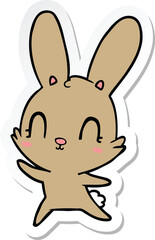 Obraz na płótnie Canvas sticker of a cute cartoon rabbit dancing