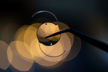 photo of intra ocular lens IOL for treating cataract infront lights