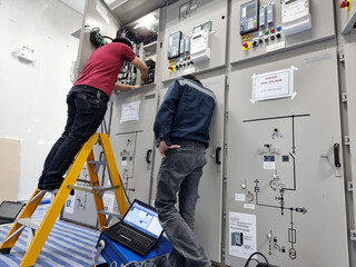 Protection relay function testing at 22kV switchgear by the commissioning engineer.