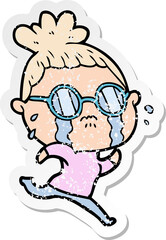 distressed sticker of a cartoon crying woman wearing spectacles