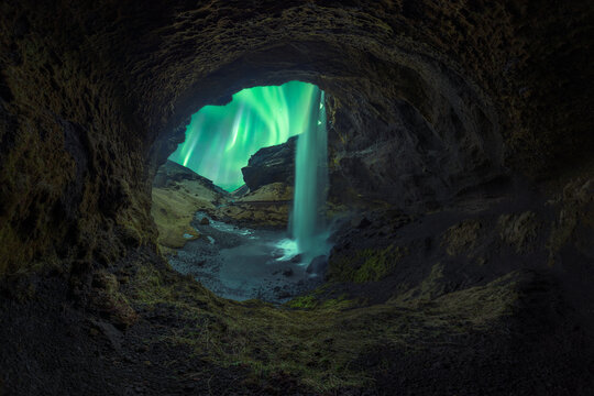 View from cave of waterfall and northern lights