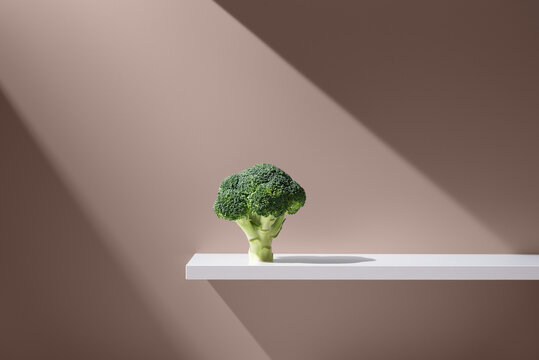 Green broccoli on white plain surface