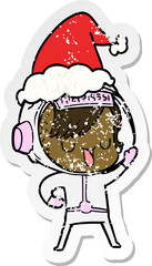 hand drawn distressed sticker cartoon of a astronaut woman wearing santa hat