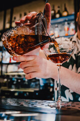man hand bartender making cocktail in glass on the bar counter