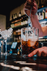 man hand bartender making cocktail in glass on the bar counter
