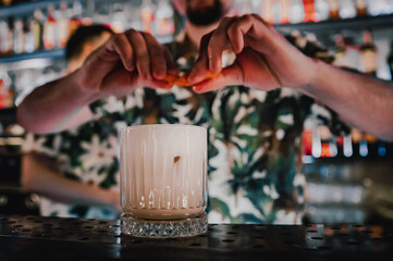 man hand bartender making cocktail in glass on the bar counter