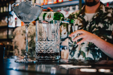 man hand bartender making cocktail in glass on the bar counter