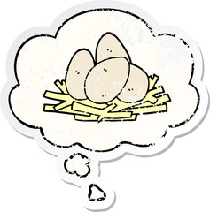cartoon eggs in nest with thought bubble as a distressed worn sticker