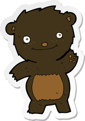 sticker of a cartoon waving black bear cub