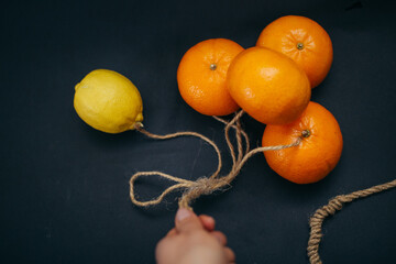 tangerines and lemon on a string like balloons