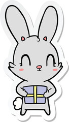 Fototapeta na wymiar sticker of a cute cartoon rabbit with present