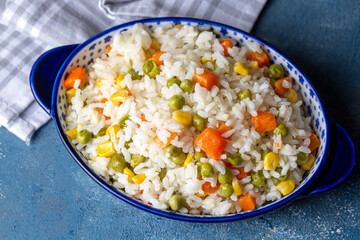 Delicious vegetable rice pilaf with green peas, carrots and sweet corn (Turkish name; sebzeli pilav)
