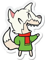 sticker of a laughing fox wearing winter clothes