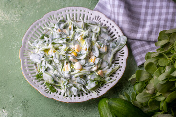Purslane salad with yogurt in bowl on wooden background.